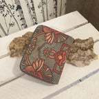 Détail des motifs floraux verts sur portefeuille en liège